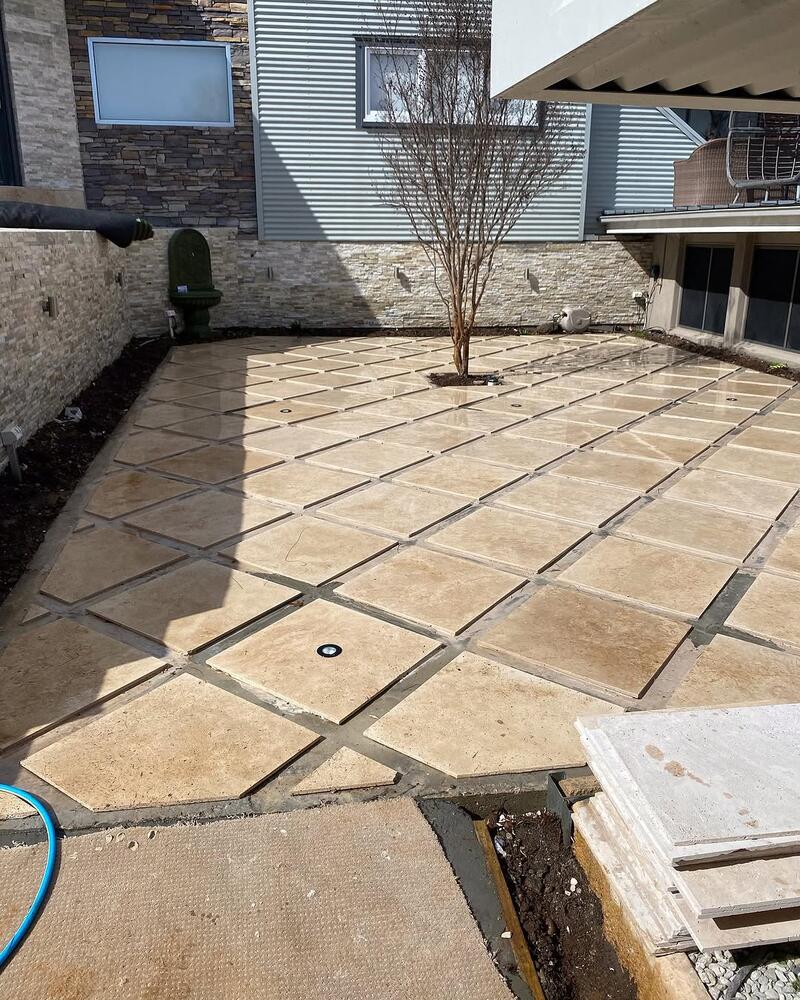 Large stone pavers laid in a courtyard around a young tree