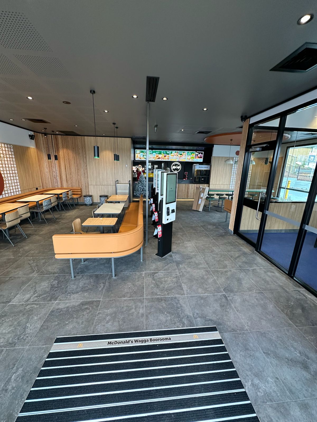Grey floor tiles in a McDonald's dining area with orange booth seating